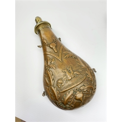 Victorian large copper powder flask embossed with a hunting scene within an oak leaf border with stag and fox heads, the nozzle marked 'Extra Quality Sykes Patent', fitted with four suspension rings H24cm; together with Victorian leather shoulder shot flask with Sykes nozzle L80cm (2)