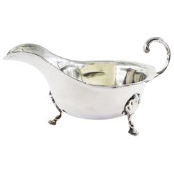 1930's silver sauce boat, of typical form with shaped rim and flying scroll handle, upon three hoof feet, hallmarked Sydney Hall & Co, Sheffield 1932, approximate weight 4.41 ozt (137.3 grams)