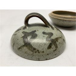 Janet Leach (American, 1918-1997) for Leach Pottery; speckled studio pottery vase of shouldered ovoid form with speckled brown decoration and trailing green and brown glaze upon beige and brown ground, with impressed J.L. monogram and Leach Pottery mark beneath, together with a Jeremy Leach blue speckled lidded circular dish with loop handle, impressed J.L, tallest H11cm