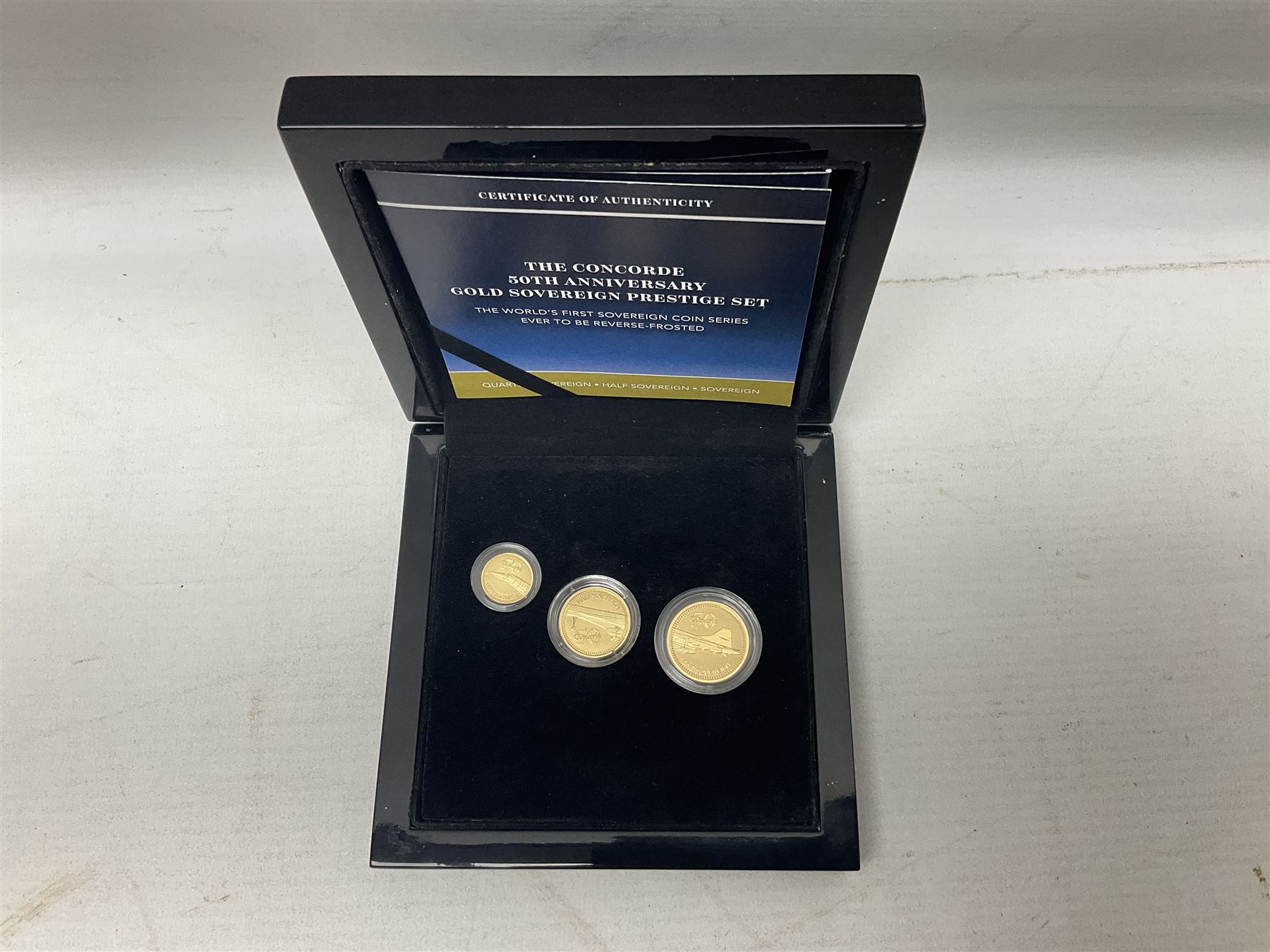 Queen Elizabeth II Gibraltar 2019 'The Concorde 50th Anniversary Gold Sovereign Prestige Set', comprising full, half and quarter sovereigns, cased with certificate, together with various items of Concorde memorabilia including cased binoculars, flight certificate for Heathrow to Moscow, 'Concorde Through The Lines' photographic tribute book etc