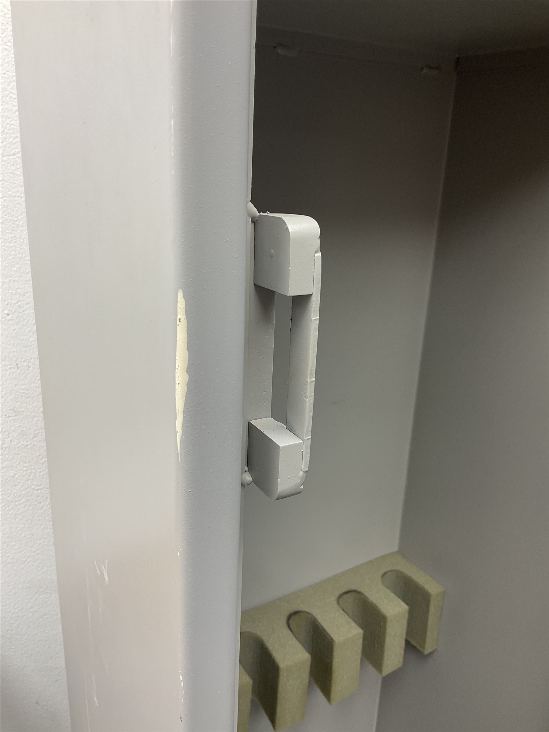 Two-tone grey steel wall-mounting gun cabinet by Sambell Engineering to accommodate six guns with fixed shelf over, gun space int. H132cm W36.5cm D23.5cm, the single double-locking door with two sets of keys, ext. H154cm W37cm D27cm