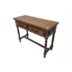 Spanish oak side table, fitted with two drawers with moulded facias, raised on turned supports united by stretcher