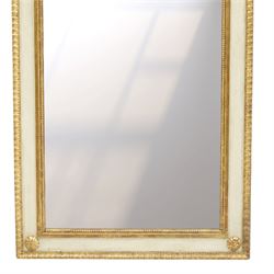 Neoclassical design pair of cream painted and gilt pier mirrors, projecting moulded cornices above frieze panels decorated with ribbon-tied musical trophies, rectangular plates within beaded slips, the outer frames with repeating leaf borders and flowerhead roundels