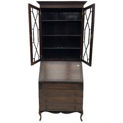 Early 20th century mahogany bureau bookcase, the projecting cornice over blind fret work frieze and two astragal glazed doors, sloped hinged lid enclosing fitted interior and leather inset, four graduating drawers, shaped apron and cabriole feet