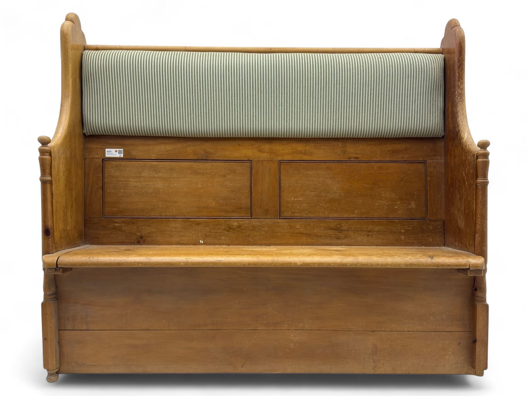 Early 20th century waxed pine pew, inset upholstered striped back panel with hinged box seat enclosing storage, shaped arms and turned supports