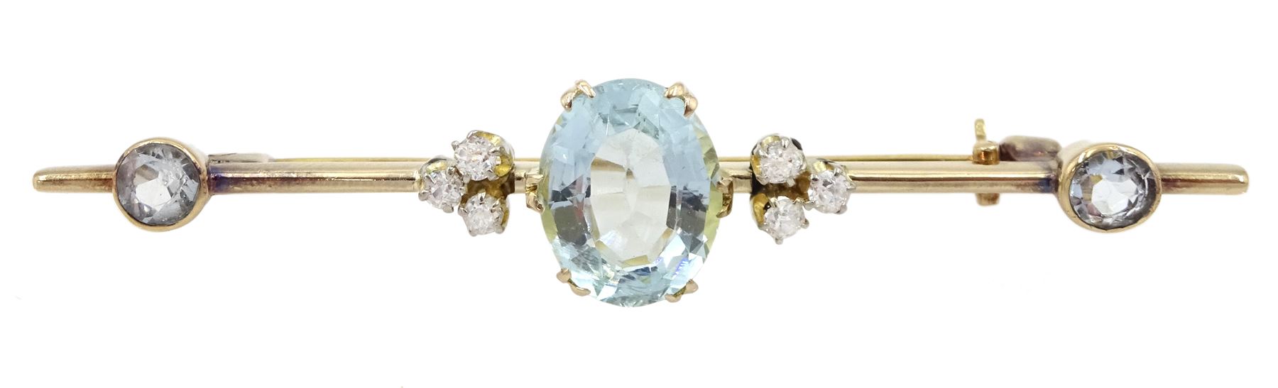 Early 20th century gold aquamarine and diamond brooch, the oval central aquamarine of approx 3.10 carat, set with three old cut diamonds either side and two aquamarines to each end
