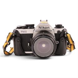 Nikon FM2 film camera body serial no. 7814849 with a Sigma 24mm lens serial no.5083190, camera user manual and Nikon carrying case