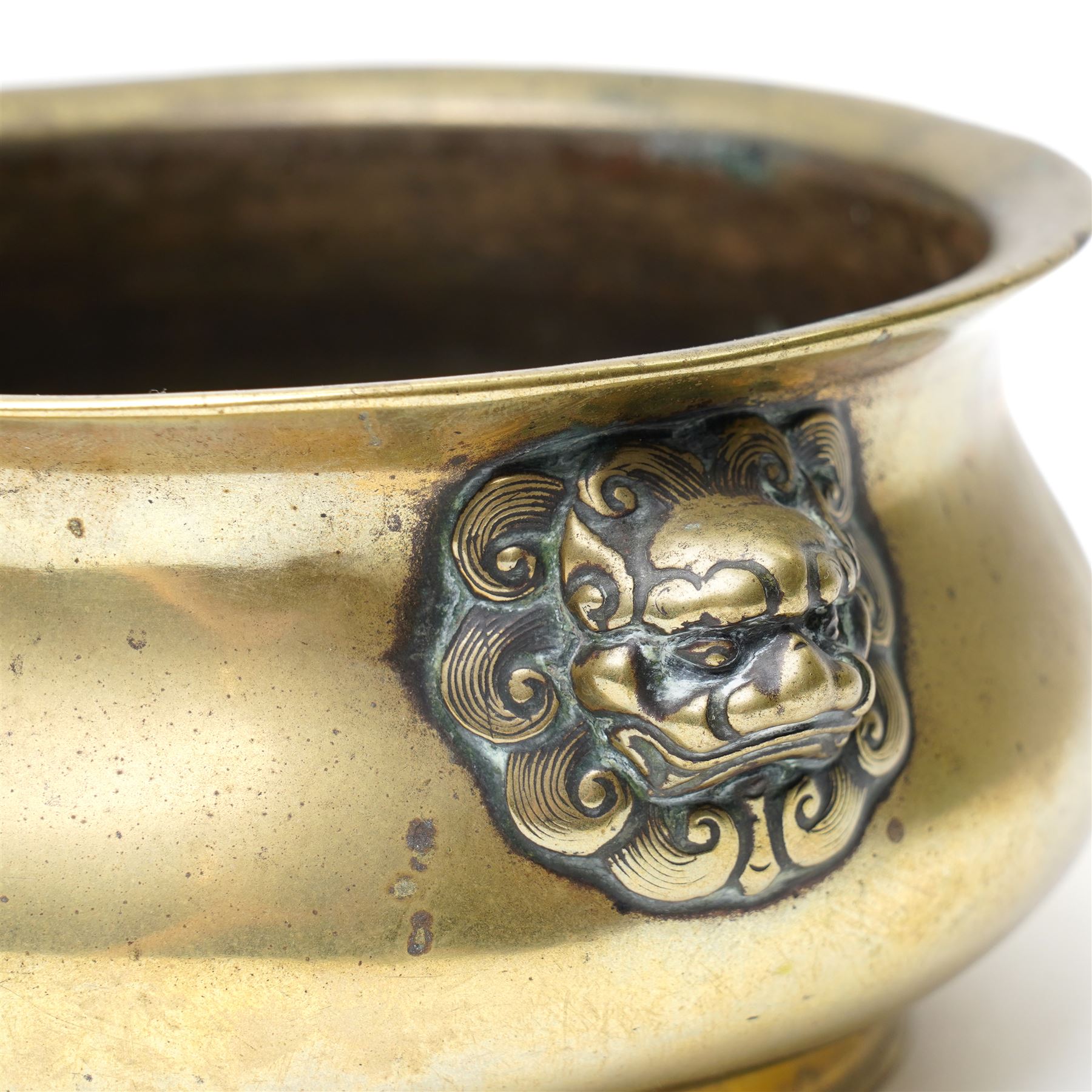 Chinese Ming dynasty gilt bronze censer, of circular bellied form with temple lion mask handles, upon a circular foot, six character Xuande mark to base, D15.5cm