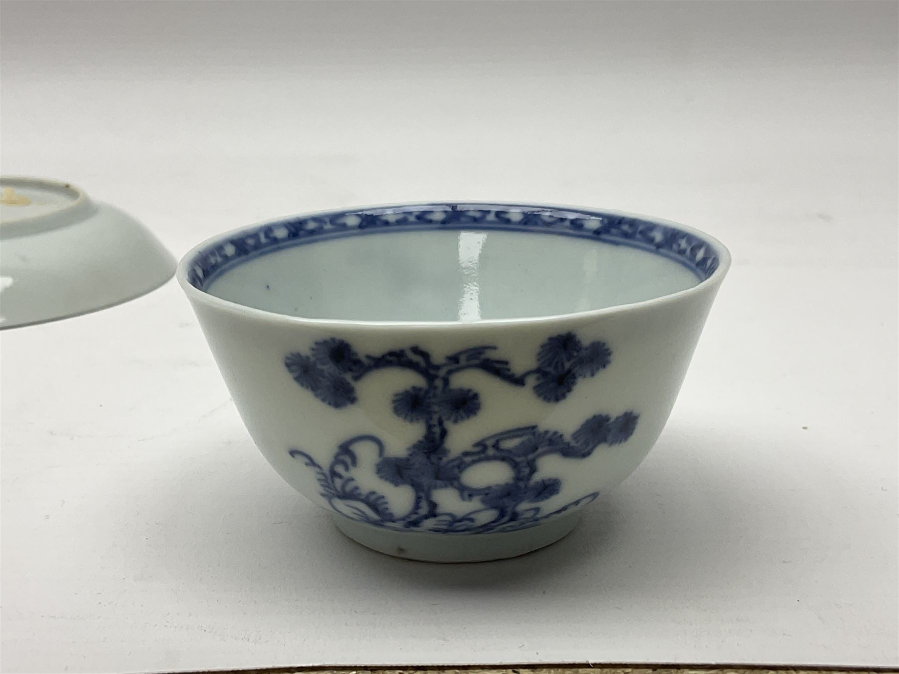 Chinese Nanking Cargo tea bowl and saucer, each decorated with pin tree, saucer with Christie's lot label beneath, tea bowl D7.5cm, saucer D11.5cm