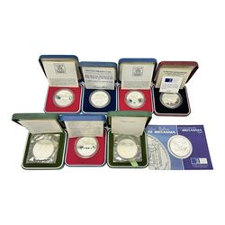 Seven The Royal Mint United Kingdom sterling silver proof crown coins, comprising two 1972, three 1977, 1981 and 1993, all cased with certificates and a Queen Elizabeth II 2001 one ounce fine silver Britannia coin on card (8)