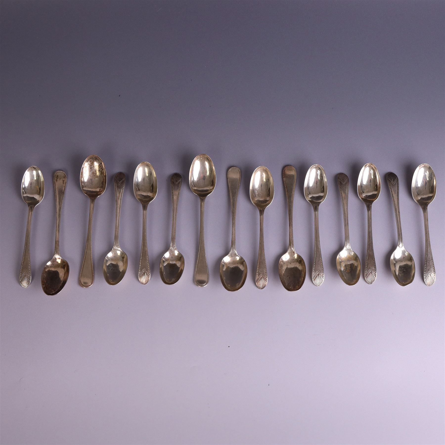 Set of ten silver late Victorian silver teaspoons, with beaded rimg and engraved fan design, hallmarked Thomas Bradbury & Sons, London 1891, and a set of five Victorian silver teaspoons with beaded rim, hallmarked Thomas Prime & Son, Birmingham 1890