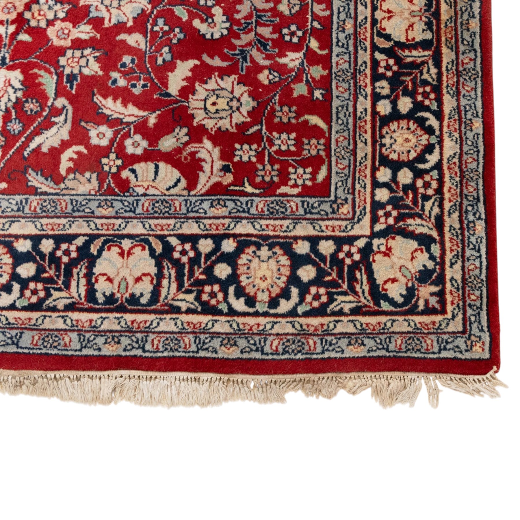 Persian crimson ground rug, interlacing floral stems linking ivory palmettes, rosettes and serrated leaves, within a navy floral border flanked by ivory patterned guards