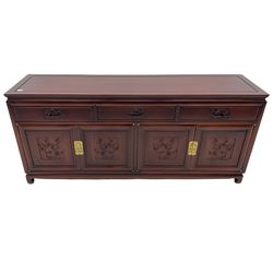 Chinese hardwood sideboard, three drawers above four cupboards, the doors relief carved with flowers and birds 