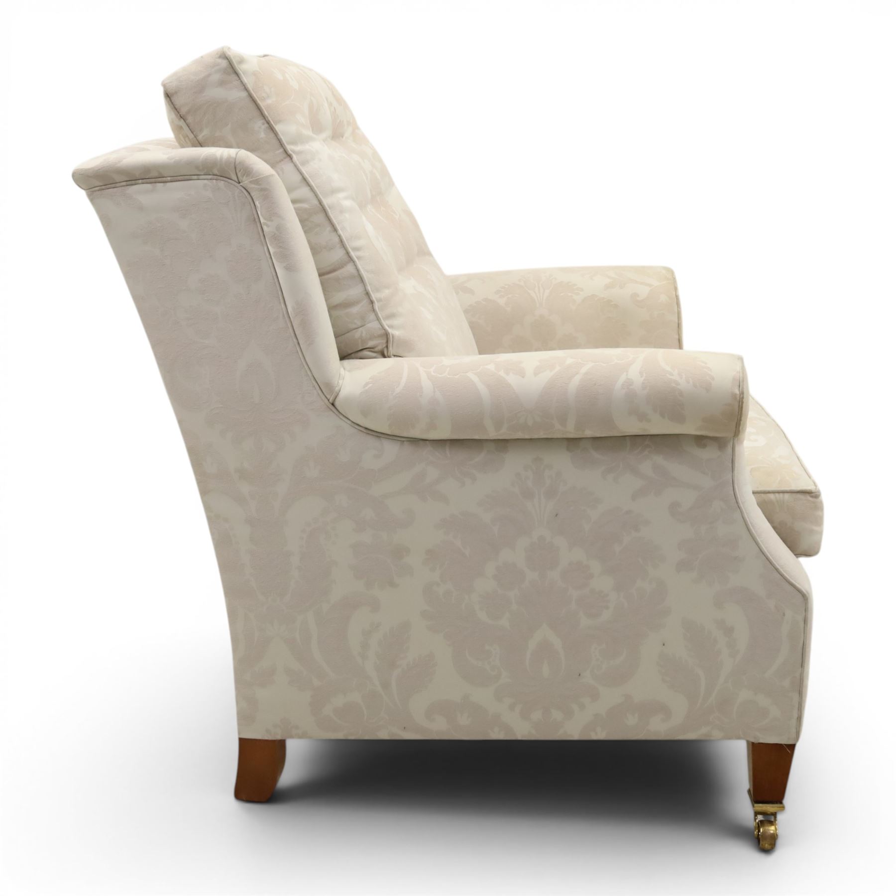 Duresta England - armchair upholstered in beige damask fabric, with deep seat and button back, loose seat cushions with scrolled arms, raised on brass castors