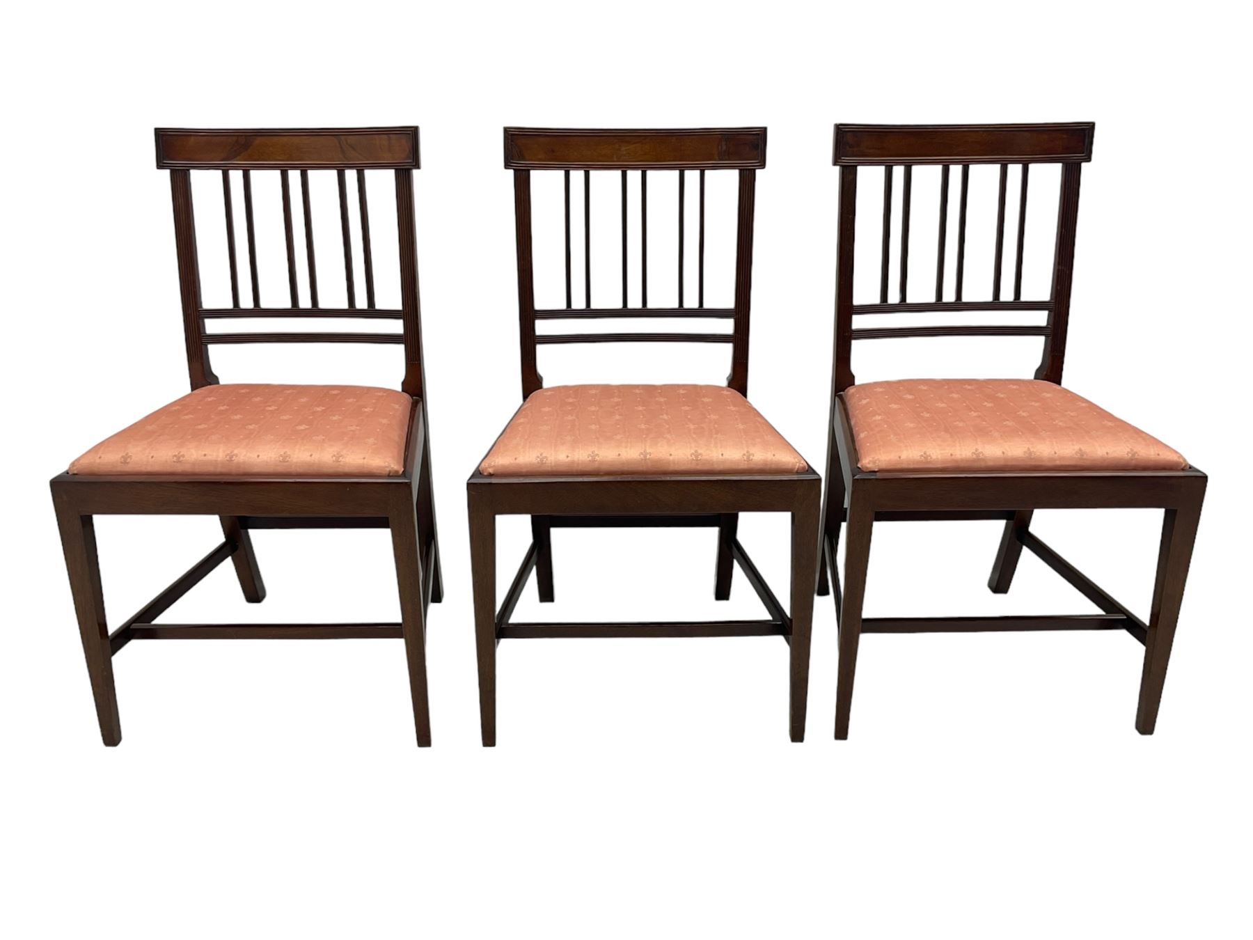 Early 20th century Regency design mahogany tilt-top table, circular top with edge banding, supported by a central turned pedestal with four reeded sabre supports terminating in castors; six chairs with pink upholstered drop in seats (7)