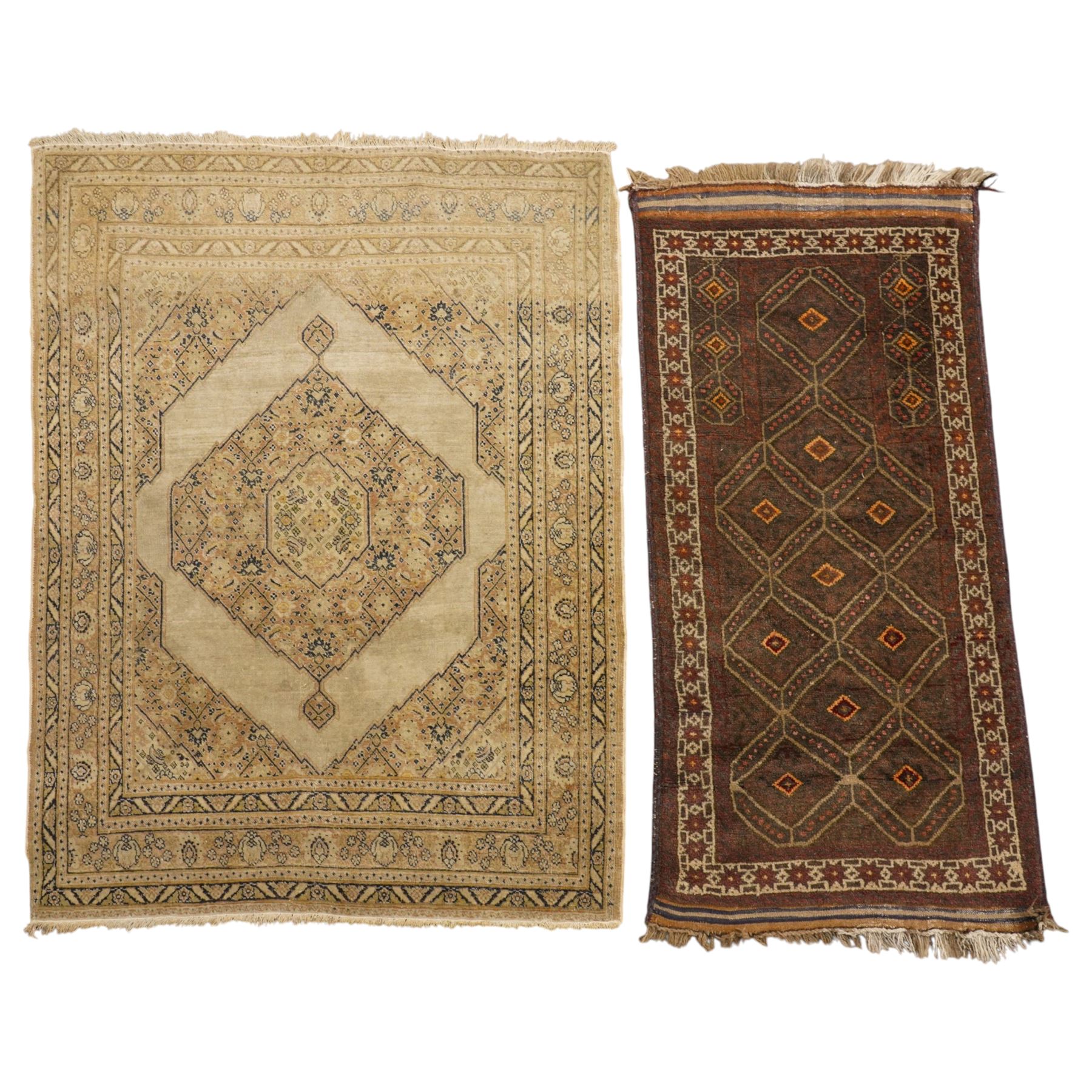 Two hand-knotted rugs, comprising Persian medallion rug and tribal rug, Persian hand-knotted rug, ivory ground centred by shaped floral medallion with pendants, surrounded by stylised flowerheads and foliate motifs, enclosed by multiple floral and geometric borders, H155cm, W123cm; tribal hand-knotted rug, dark brown ground with repeating linked geometric diamond medallions in orange and green, enclosed by ivory geometric border, striped ends with fringes, H150cm, W71cm