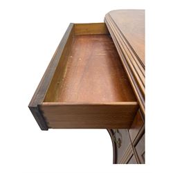 Late 20th century Italian walnut sideboard, serpentine front and bow-shaped top with highly figured veneer, single checkered-pattern frieze drawer over two drawers with central foliage cartouche, flanked by hinged frieze drawers over cupboards, on turned and carved supports