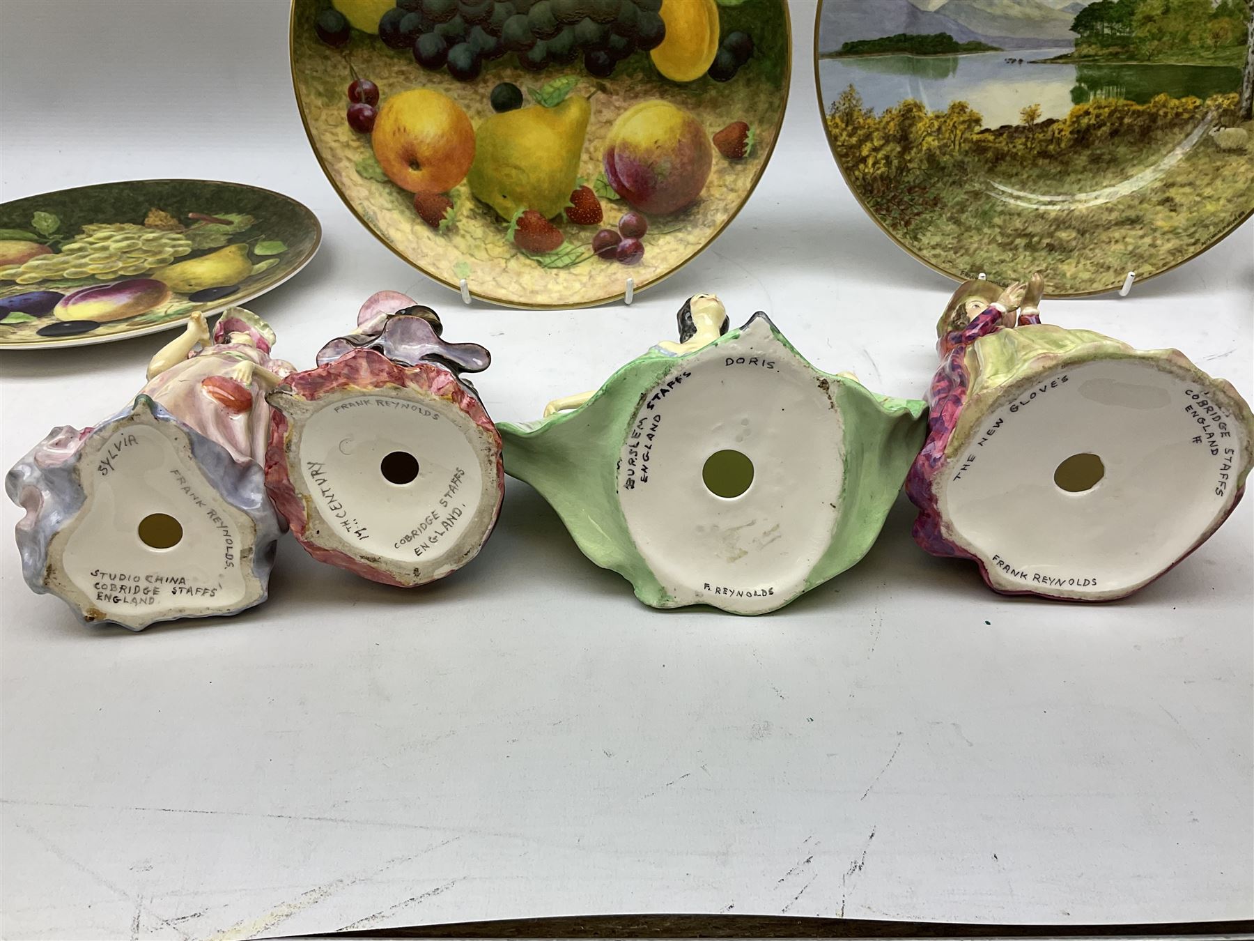 Four Frank Reynolds figures of ladies together with five plates painted by the same artist