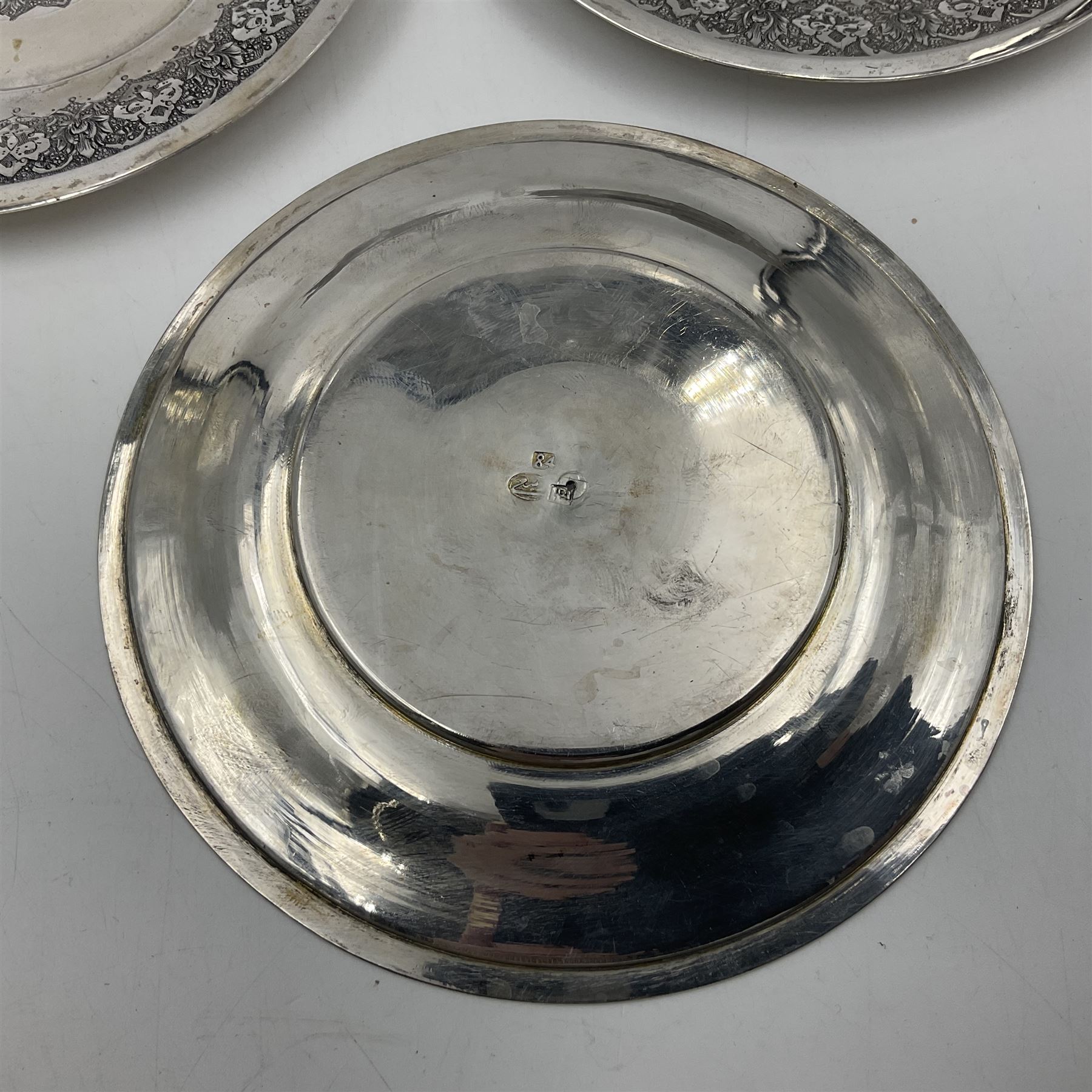 Early/mid 20th century Persian silver tea service, comprising circular serving tray, teapot, twin handled sucrier and cover, milk jug, five tea glasses with six silver holders, six tea spoons, and pair of sugar tongs, each profusely chased with foliate arabesque decoration, each bearing marks including 84 for 840 fineness, tray D40cm, teapot H16cm