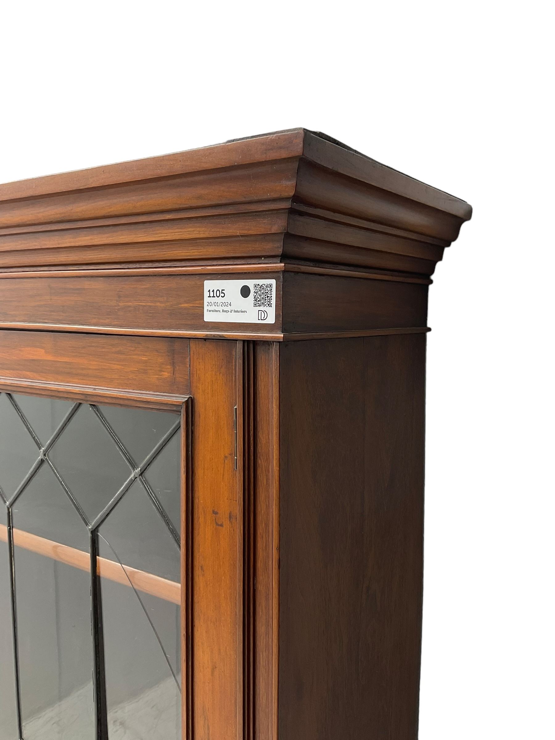 Early 20th century walnut display cabinet, projecting moulded cornice over two lead glazed doors, the interior fitted with three adjustable shelves, on cabriole supports