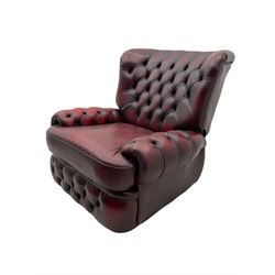 Traditional reclining armchair, upholstered in deeply buttoned oxblood leather