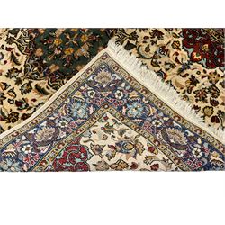Persian ivory ground rug, central green floral pole medallion within a field decorated by scrolling foliate patterns, the guarded border with repeating palmettes and floral designs