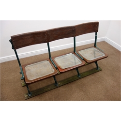  Early 20th century cast iron framed folding cinema seats, rush splat and seat, W152cm, H86cm, D40cm  