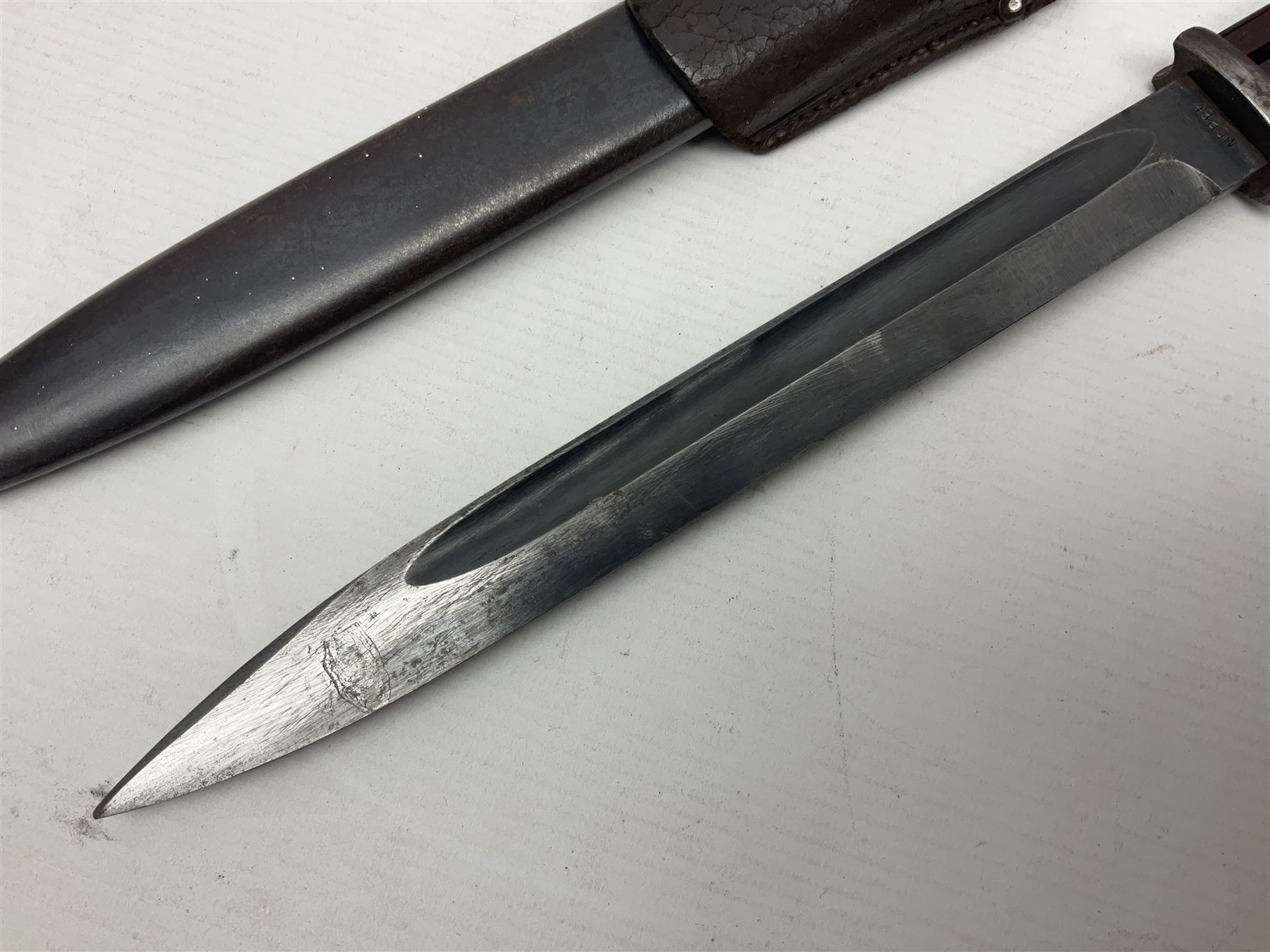 WWII German K98 Mauser bayonet by E. & F. Horster, the 24.5cm fullered blade marked 43aSW for 1943, numerous inspection marks to blade and pommel, bakelite grips and bluing to metal parts; in steel scabbard with corresponding numbers and leather frog L42cm overall
