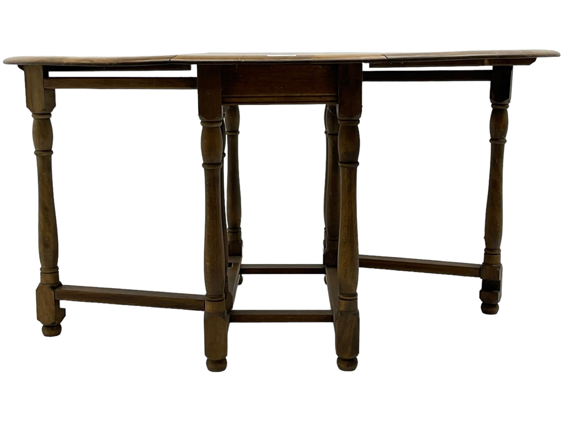 Mid-to-late 20th century oak and beech drop-leaf dining table, gate-leg action base with turned supports