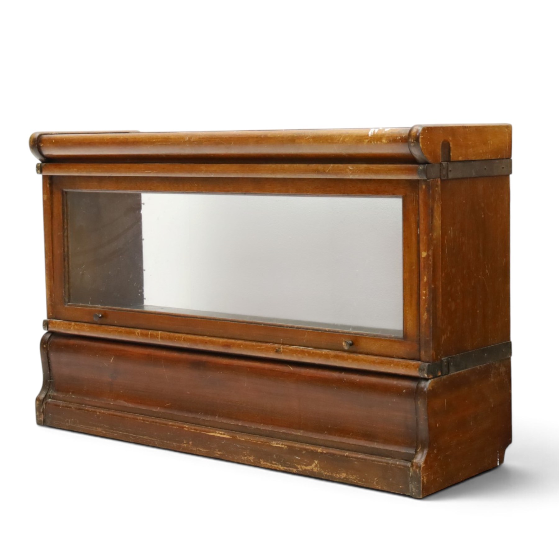 Globe Wernicke - early 20th century mahogany two-tier stacking library bookcase, fitted with glazed up-and-over doors, two drawers to the plinth base; together with a similar single-tier example (W87cm D27cm H54cm)