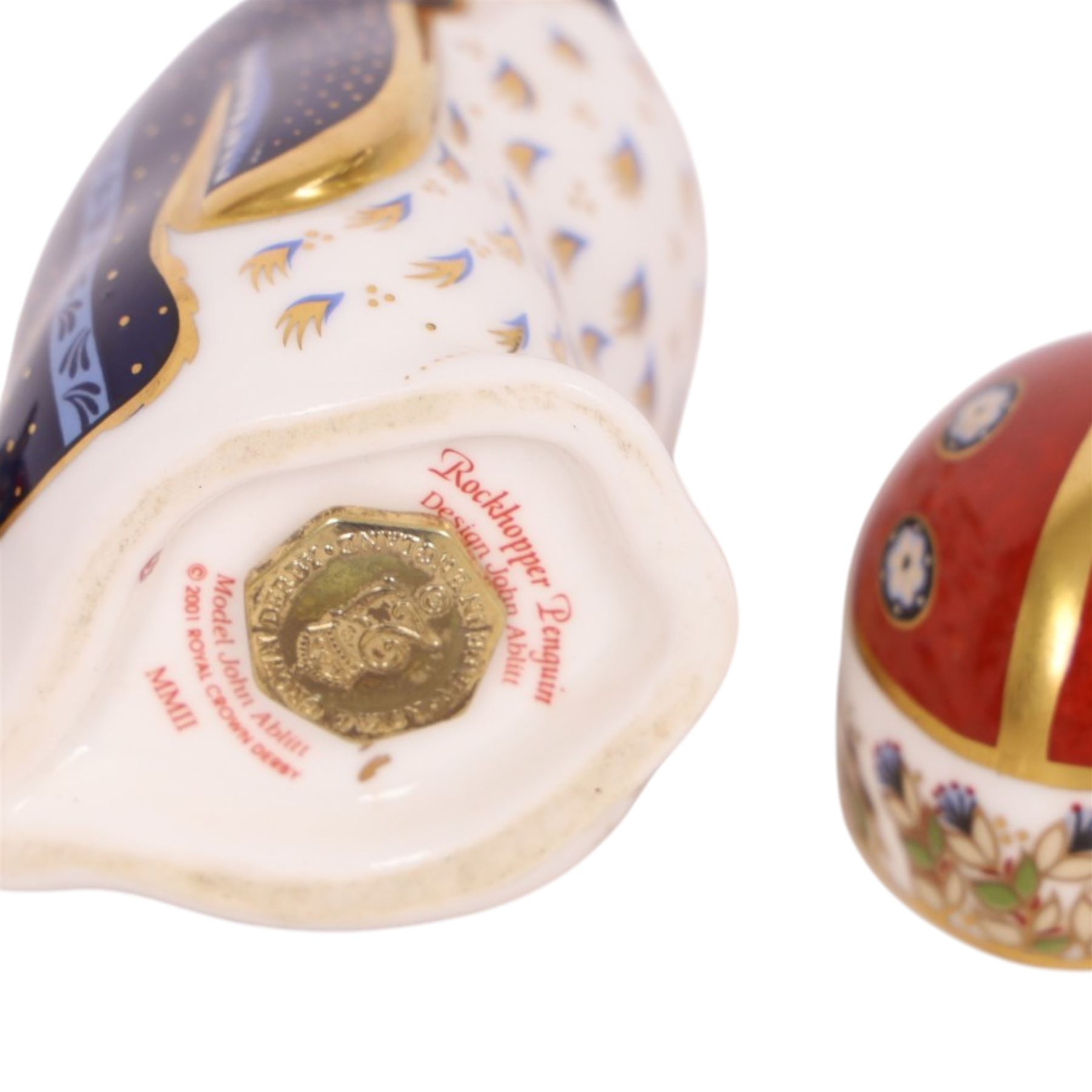 Four Royal Crown Derby paperweights, comprising Terrapin gold stopper, Rockhopper penguin gold stopper, Ladybird gold stopper and Beatle silver stopper