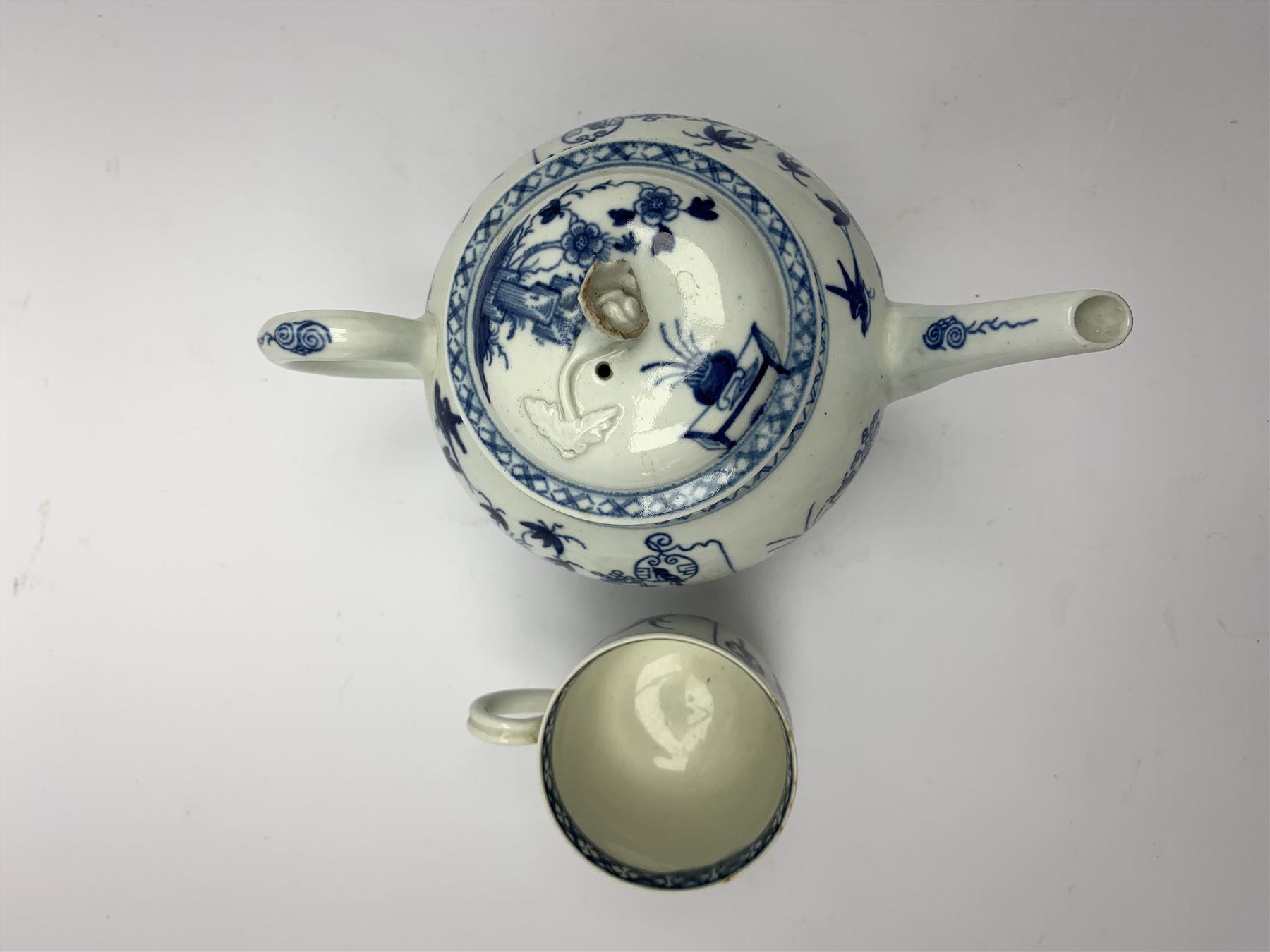 18th Century Worcester teapot, circa 1765-70, decorated in the Bird in the ring pattern, the cover with bud finial, with crescent mark beneath, H13cm, together with a Worcester coffee cup decorated in the same pattern, with crescent mark beneath, H6.5cm