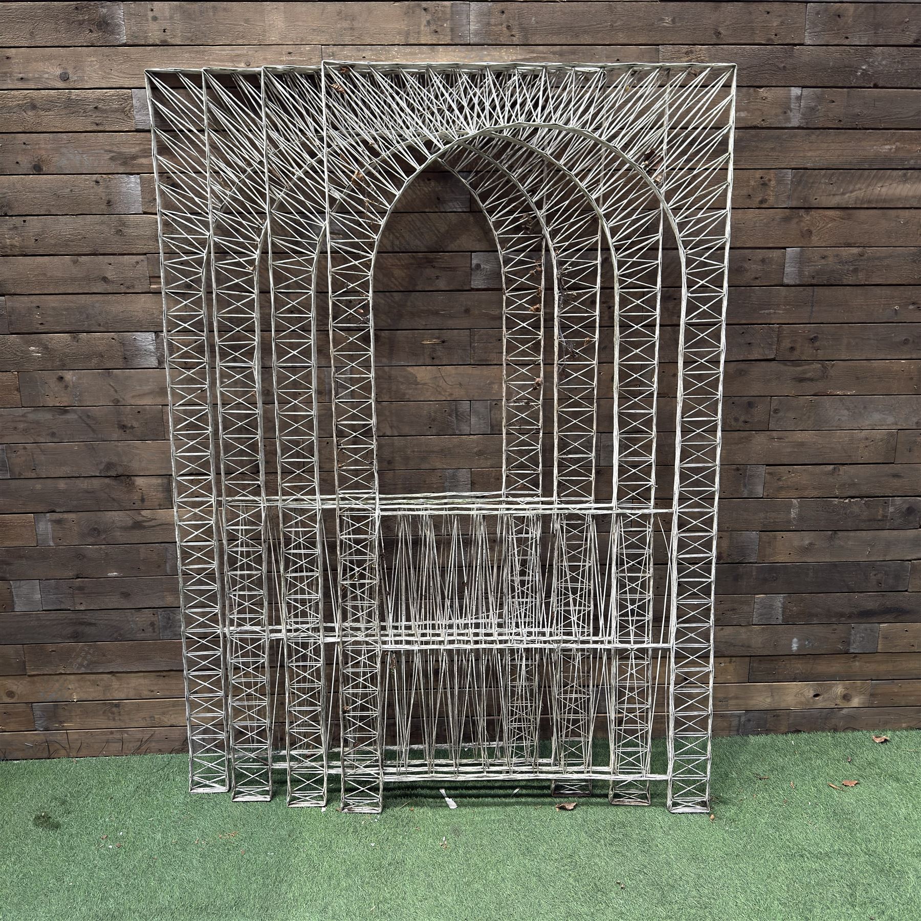 Four early 20th century French painted wicker garden trellis or dividers, rectangular form with internal arches