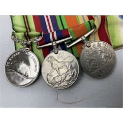 WW2 Royal Naval group of eight medals comprising OBE, hallmarked silver Distinguished Service Cross inscribed verso Lieut. J.R. McCluskie RNVR 1945, 1939-1945 Star, Atlantic Star, Africa Star, 1939-1945 War Medal, Defence Medal and Royal Naval Patrol Service Medal inscribed Lieutenant J.R. McCluskie Royal Naval Patrol Service; with seven original photographs of a sea battle 27th November 1940 against the Italian Fleet and another photographic postcard of Sir Stafford Cripps arriving on board one of the vessels.