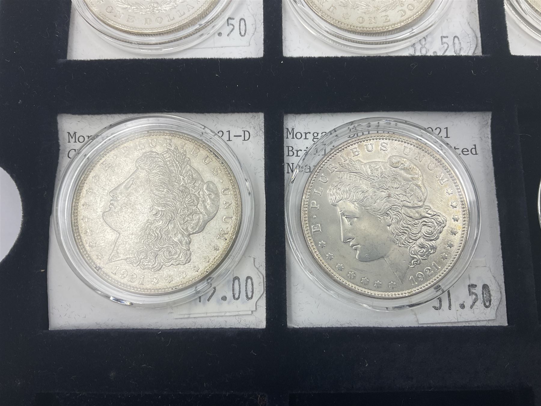 Seven United States of America silver Morgan dollar coins, dated 1884, 1901 O, 1902 O, 1903, 1904 O, 1921 D and 1921