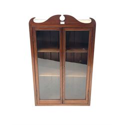 20th century stained glazed cabinet, shaped pediment, two glazed doors enclosing two fixed shelves 