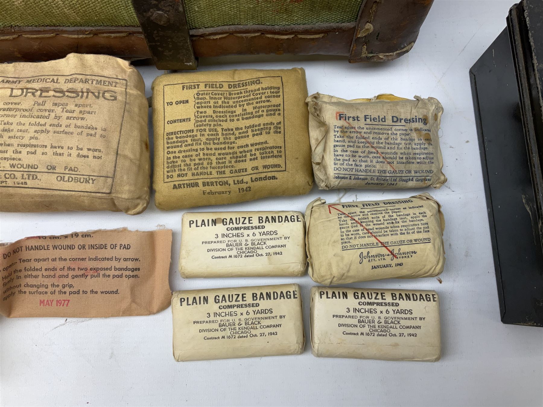 WW2 British Army RAMC 'Regimental Medical Pannier', well marked externally and dated 1941, stamped May 1943 internally, canvas covered wicker form with leather edges, hinged top and fall front with two rope carrying handles, fitted iron locking straps with securing chains; contains various unused field dressings and bandages with WW2 dates and two pillows; original label under lid L79cm