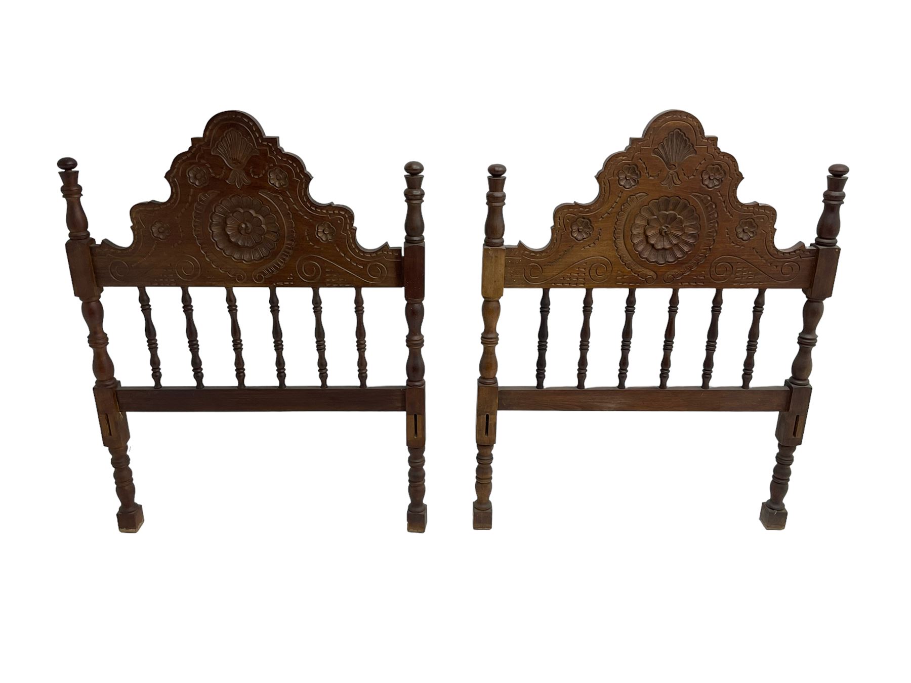 Pair Spanish stained beech single 3' bedsteads, spindle turned backs and carved with scrolling floral decoration 