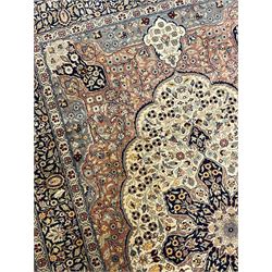 Persian Kashan peach ground rug, central rosette medallion within a field of trailing foliage and flower heads, repeating scrolling border decorated with stylised plant motifs