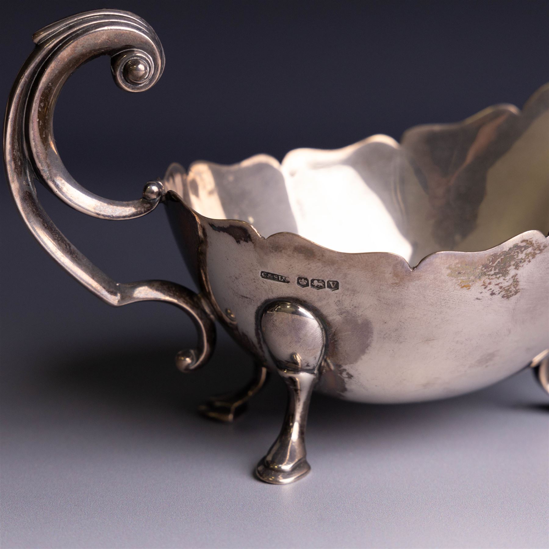 1930s silver sauceboat, of typical form with shaped rim and flying C scroll handle, upon three stepped feet, hallmarked Collingwood & Sons Ltd, Sheffield 1938