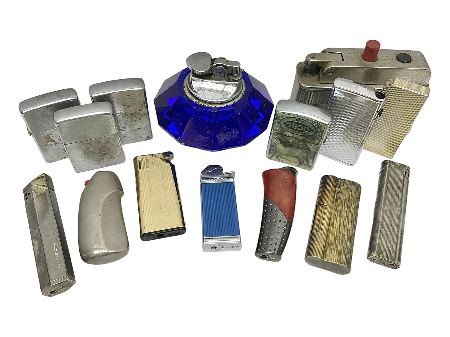 Collection of lighters, including Ronson Varaflame, Zorr Classic, Dunhill bark effect roller gas lighter, and faceted blue glass table lighter, etc