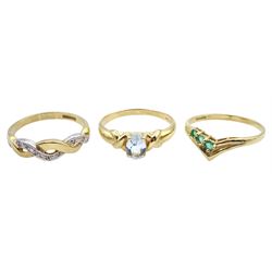 Gold single stone blue topaz ring, gold diamond crossover ring and a three stone emerald wishbone ring, all hallmarked 9ct