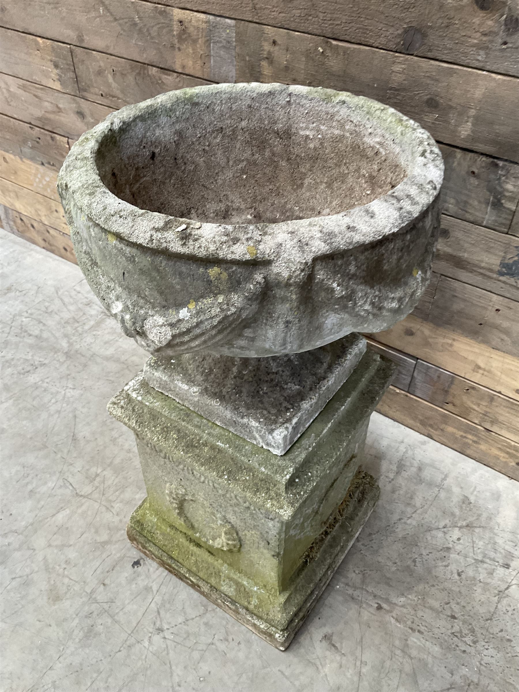 Cast stone centerpiece urn on plinth