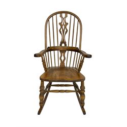 Beech Windsor rocking armchair, hoop and stick back with shaped pierced splat, dished seat, on turned supports with double H stretcher 