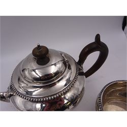 Early 20th century silver three piece tea service, comprising teapot, milk jug and open sucrier, each of squat form with gadrooned rim, the teapot with wooden handle and finial, hallmarked Edward Barnard & Sons Ltd, London 1916, teapot H14.8cm