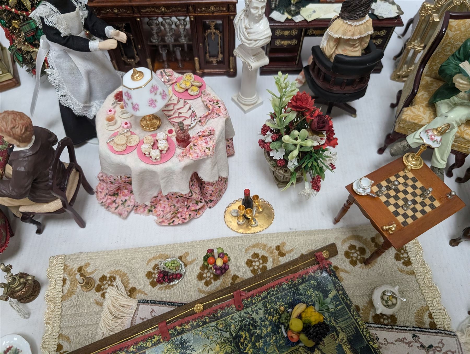 Dolls house living room and dining room furniture, including arm chairs, desk, fireplaces, dressers, tables, eight figures and a large collection of predominantly Christmas themed food, accessories and decorations