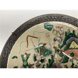 Near pair of late 19th/early 20th century Chinese Famille Verte crackle glaze chargers, decorated with mountainous landscapes containing warriors on horseback and foot, within simulated bronze incised borders, largest D40cm