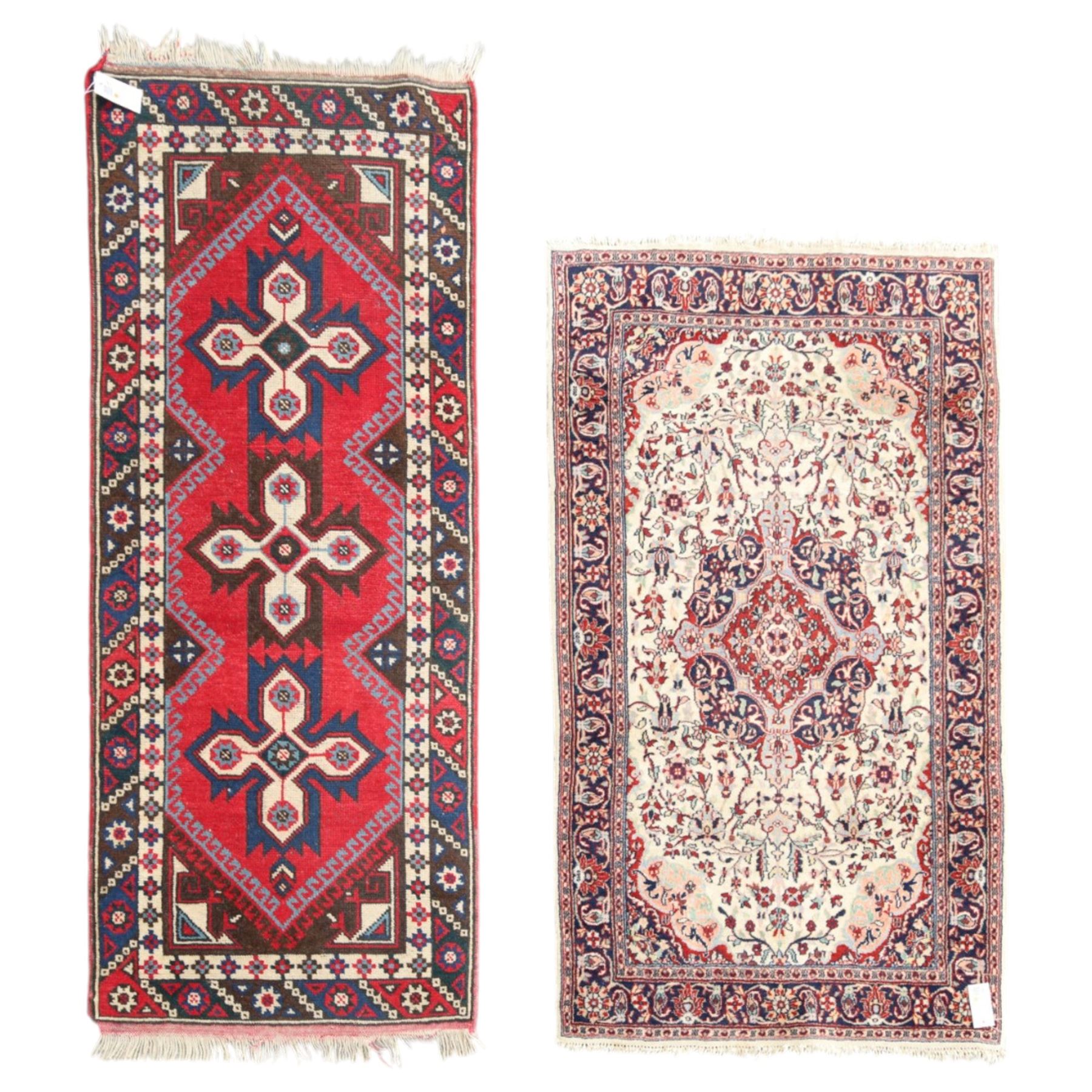 Two Persian rugs, Persian Hamadan hand-knotted rug, ivory ground centred by a terracotta medallion, surrounded by scrolling floral and foliate motifs, dark navy floral border with narrow guard stripes, fringed ends, H 176cm, W 75cm, Persian tribal hand-knotted rug, madder red ground decorated with three large geometric medallions, surrounded by angular motifs, enclosed by multiple geometric borders in dark navy, ivory and red, fringed ends, H 150cm, W 91cm