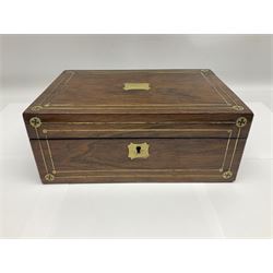 Victorian walnut sewing box, of rectangular form with brass escutcheon and inlaid brass decoration to the hinged cover, opening to reveal a lined and fitted interior and lift-out tray containing mother-of-pearl cotton reels, and other implements, H10cm D8cm W26cm