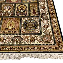Persian design carpet, the field with various size tiles decorated with stylised plant motifs, floral urns and peacocks, the main border decorated with repeating foliate motifs and trailing flower heads